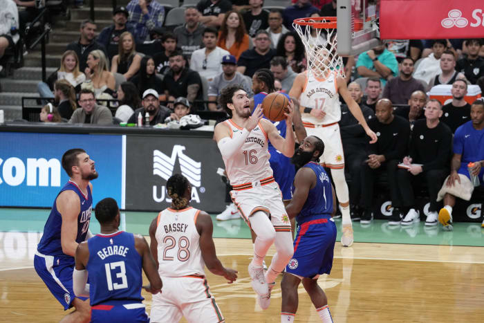 Nov 20, 2023; San Antonio, Texas, USA; San Antonio Spurs forward Cedi Osman (16) shoots in the first half against the LA Clippers at the Frost Bank Center.
